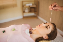 Young woman at crystal healing session in therapy room
